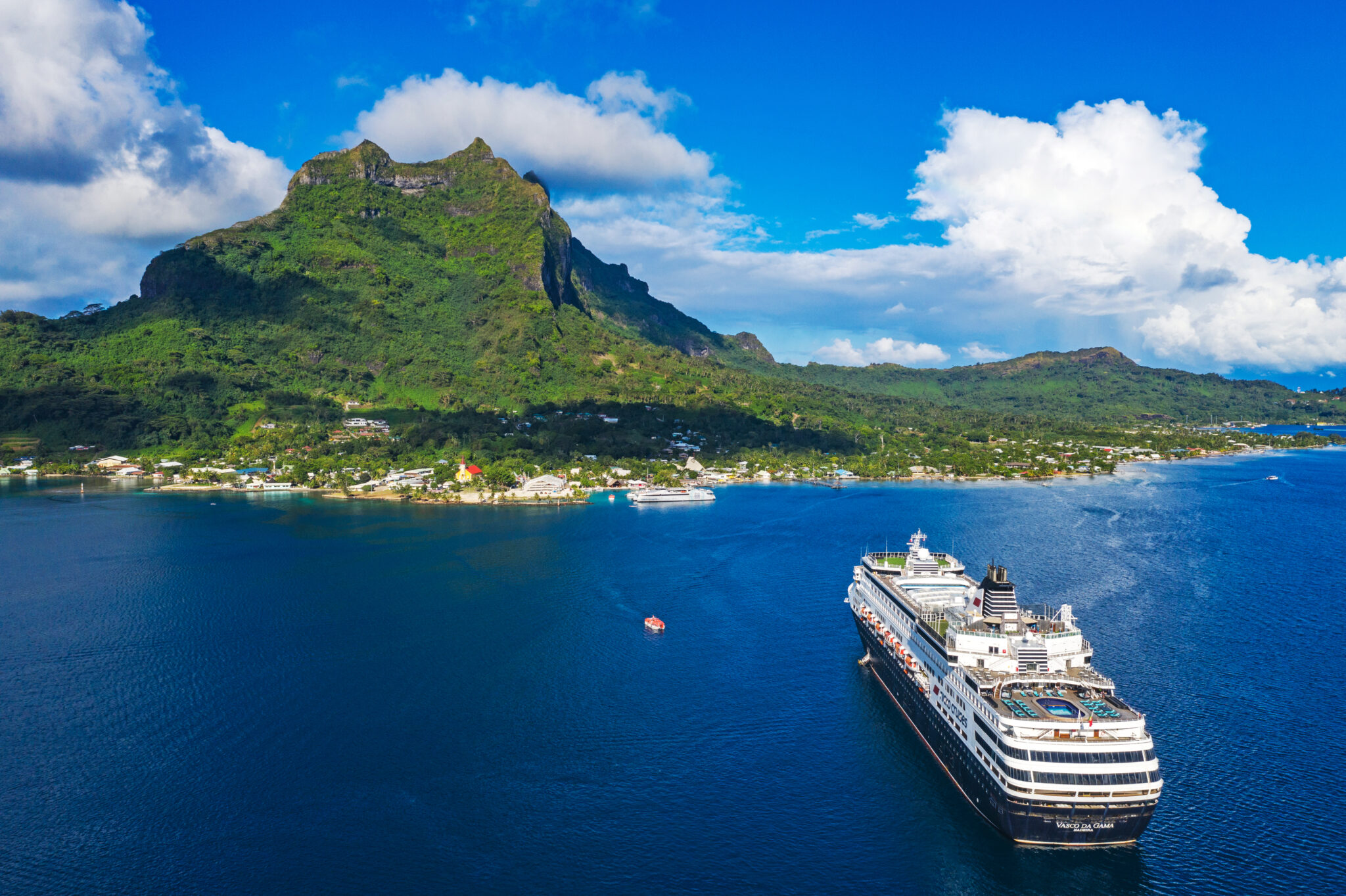 Vasco da Gama vessel in the middle of the ocean in front of a vulcan island